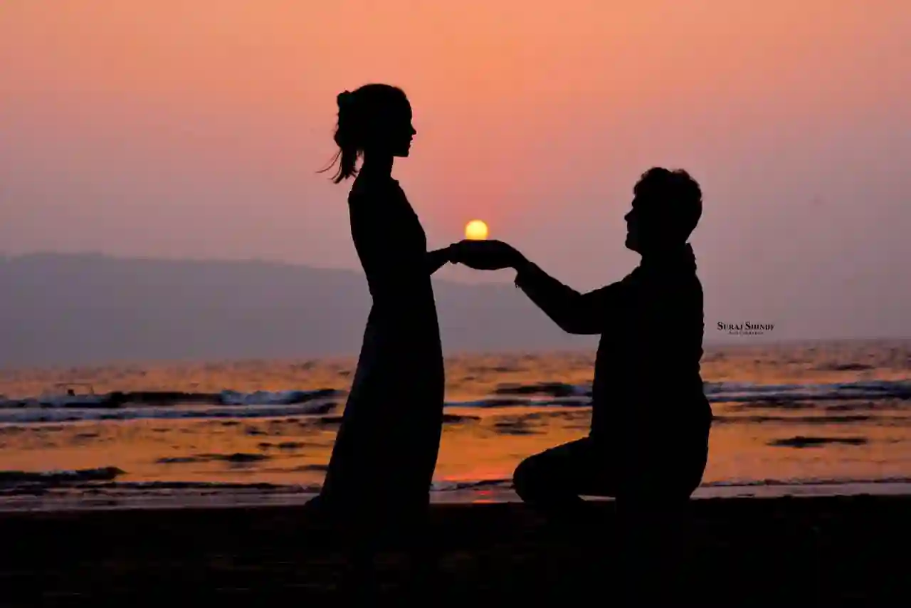 Couple watching sunset beside Pawna Lake
